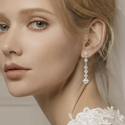 Luxurious 4 Carat Moissanite Sterling Silver Earrings on a woman.