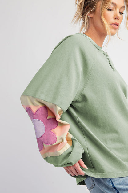 Floral patchwork oversized top with exposed seams in smoke green