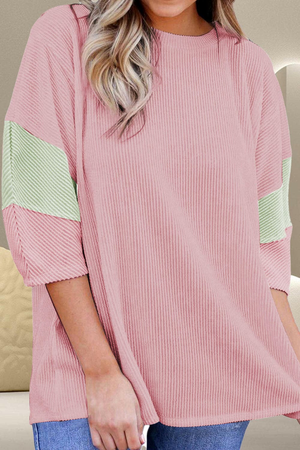 Color block round neck blouse with 3/4 sleeves in pink and green.