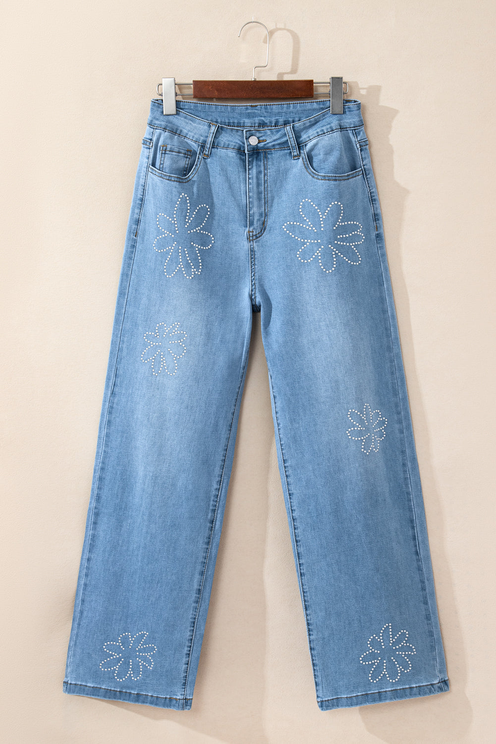 Light blue high-rise wide leg jeans with floral rhinestone embellishments