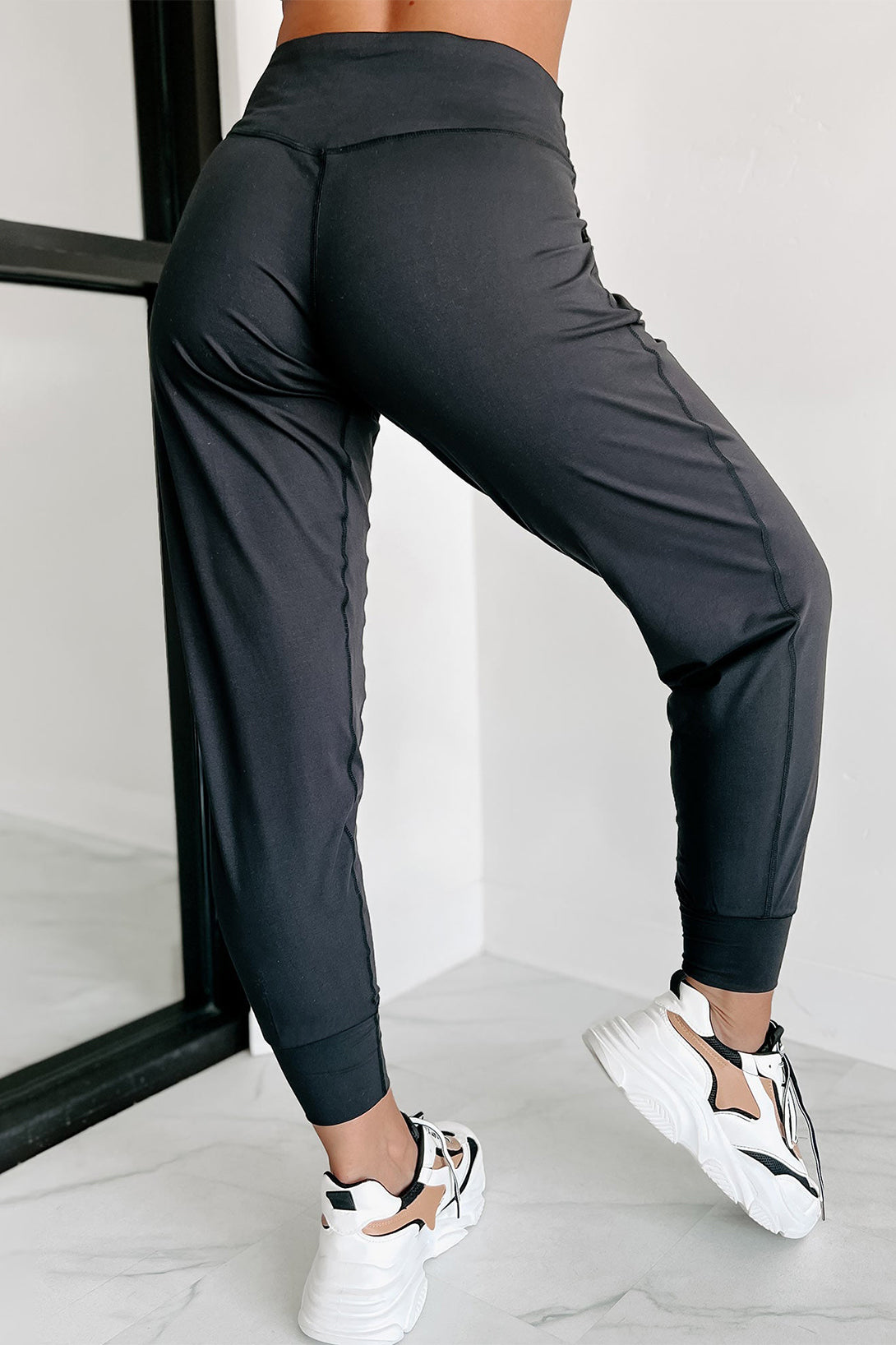 Modern high-waisted joggers with exposed seams and pockets