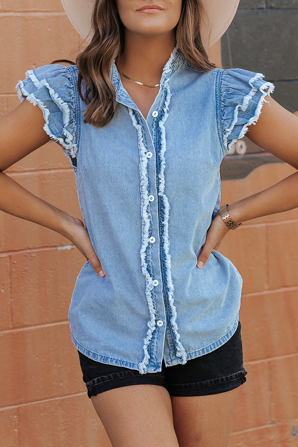 Chic ruffled denim top with button front and frayed hem