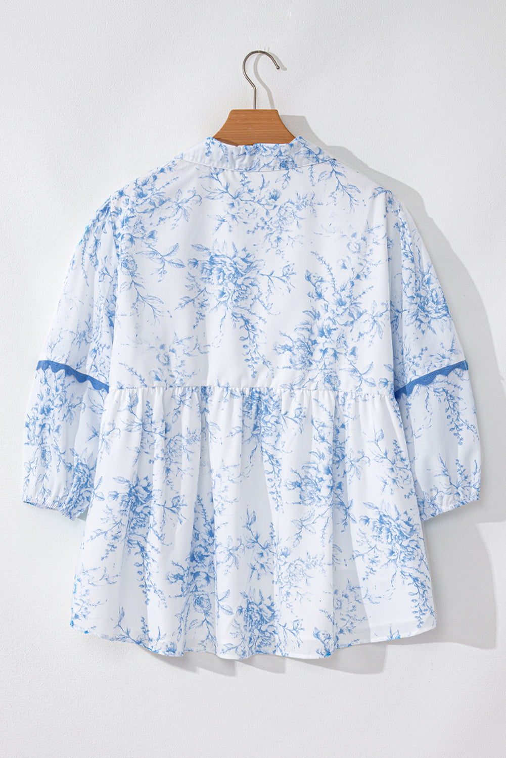 Chic sky blue floral blouse with tied collar and 3/4 sleeves