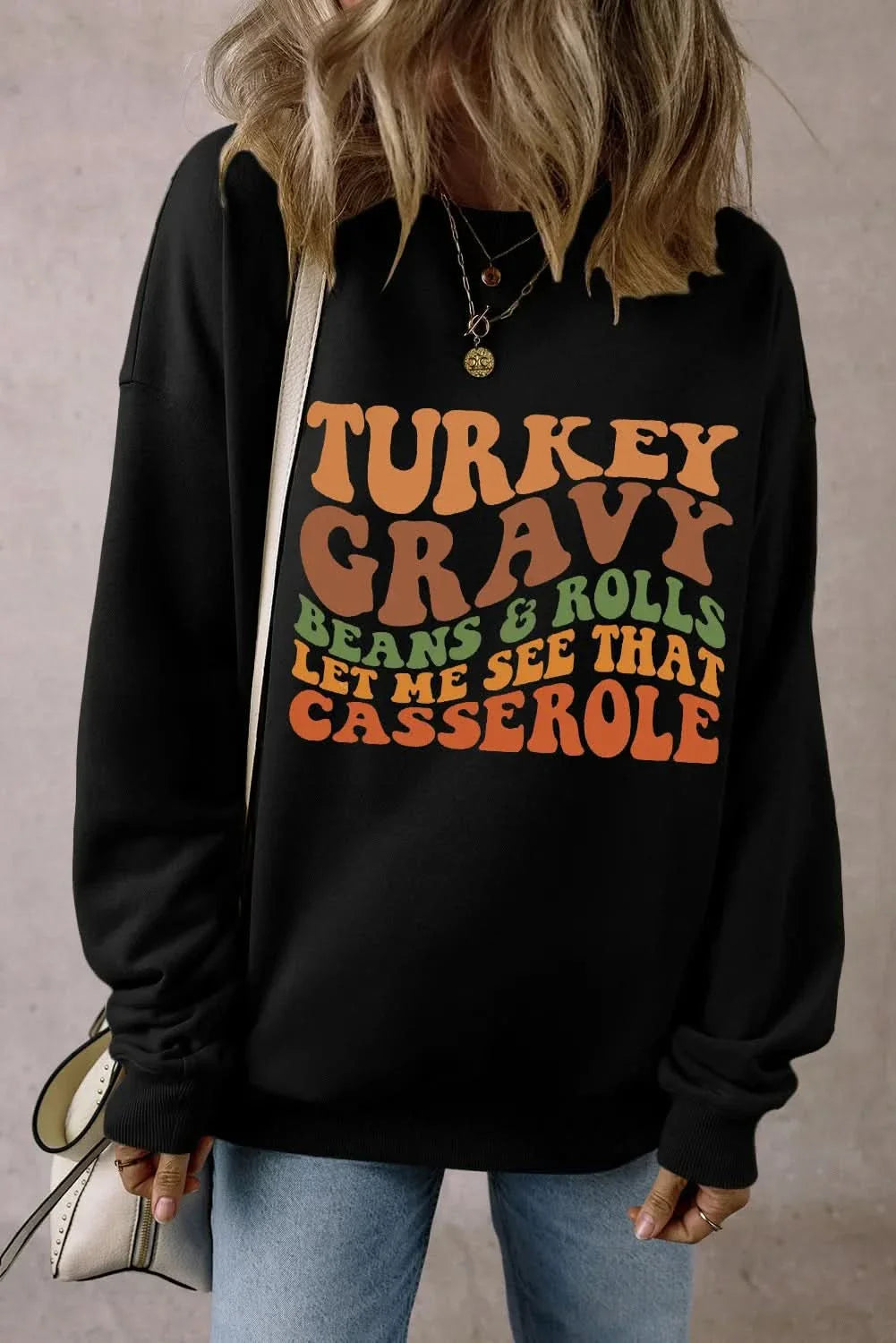 Letter graphic round neck long sleeve sweatshirt, black with colorful text design.