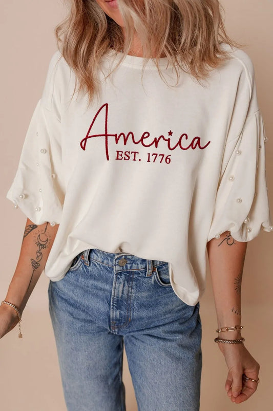 AMERICA EST 1776 Embroidered Pearl Beaded Sleeve T Shirt - Main product image by Simply Love