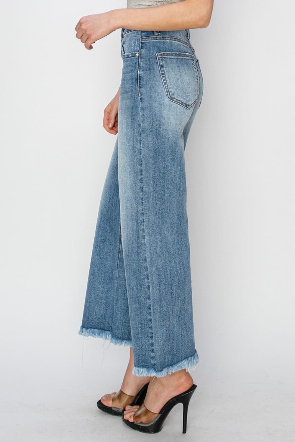 RISEN Raw Hem Cropped Wide Leg JeansHigh Rise Raw Hem Cropped Wide Leg Jeans are the perfect addition to your wardrobe. With their high rise fit, raw hem detail, and wide leg silhouette, these jeans ofLove Salve RISEN Raw Hem Cropped Wide Leg JeansJeans