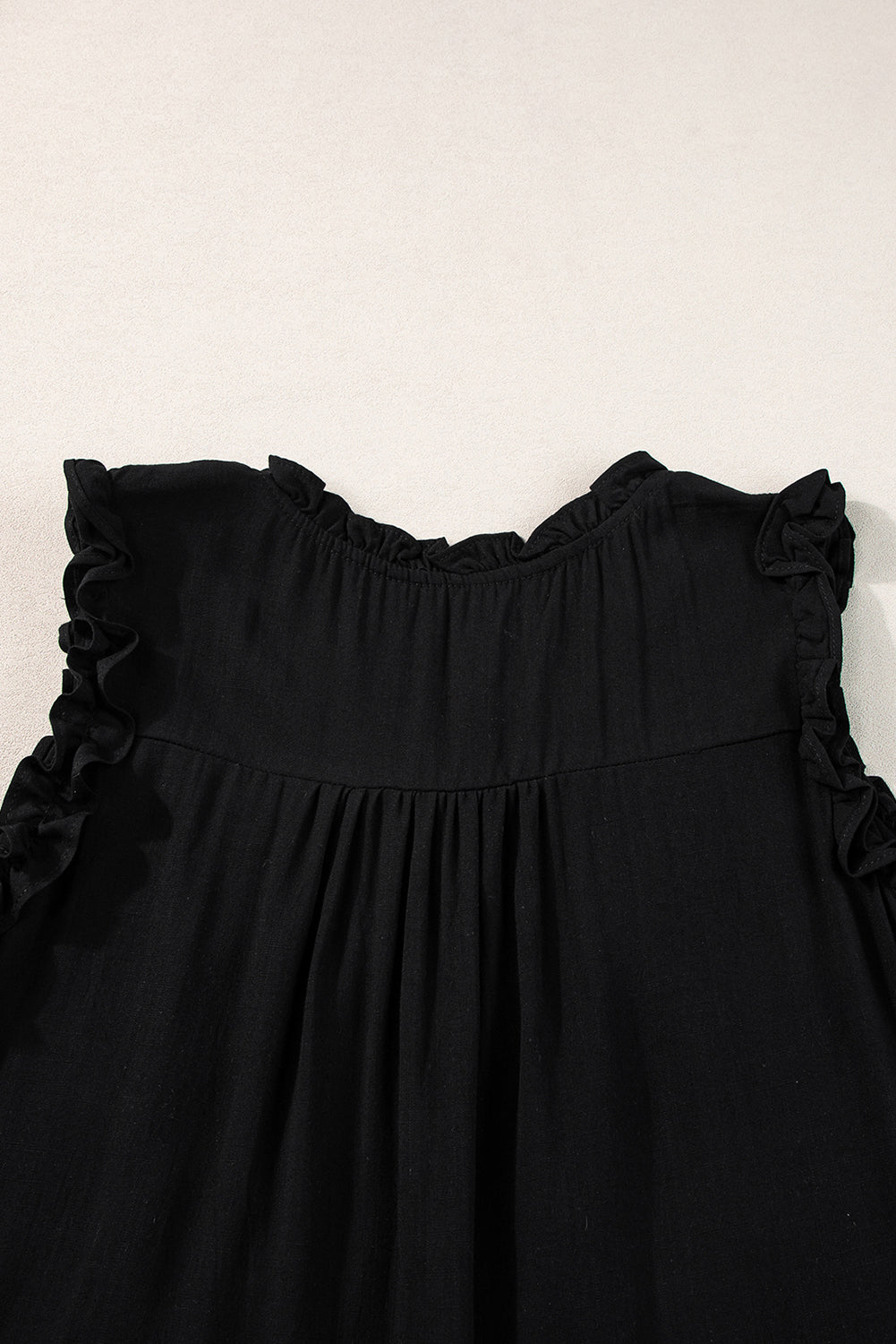 Chic black ruffled neck tank top with button detail