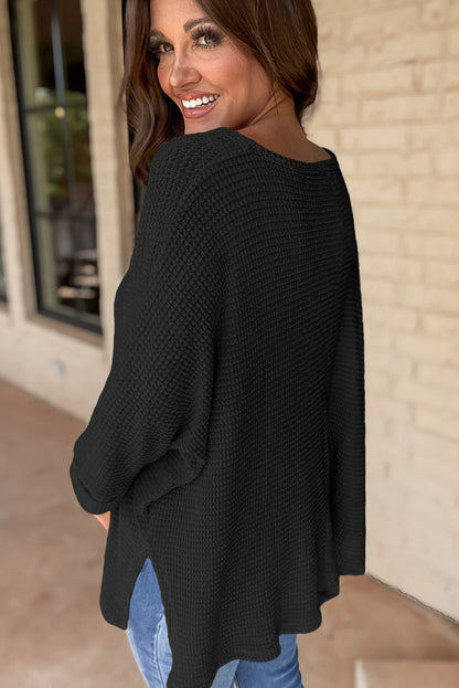 Chic black waffle knit V-neck top with side slits and loose fit