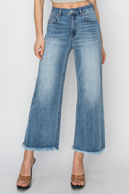 RISEN Raw Hem Cropped Wide Leg JeansHigh Rise Raw Hem Cropped Wide Leg Jeans are the perfect addition to your wardrobe. With their high rise fit, raw hem detail, and wide leg silhouette, these jeans ofLove Salve RISEN Raw Hem Cropped Wide Leg JeansJeans