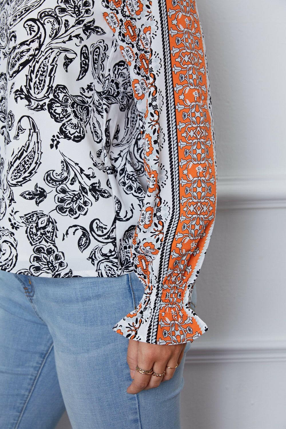 Tassel Tie Neck Printed Smocked Long Sleeve Blouse.