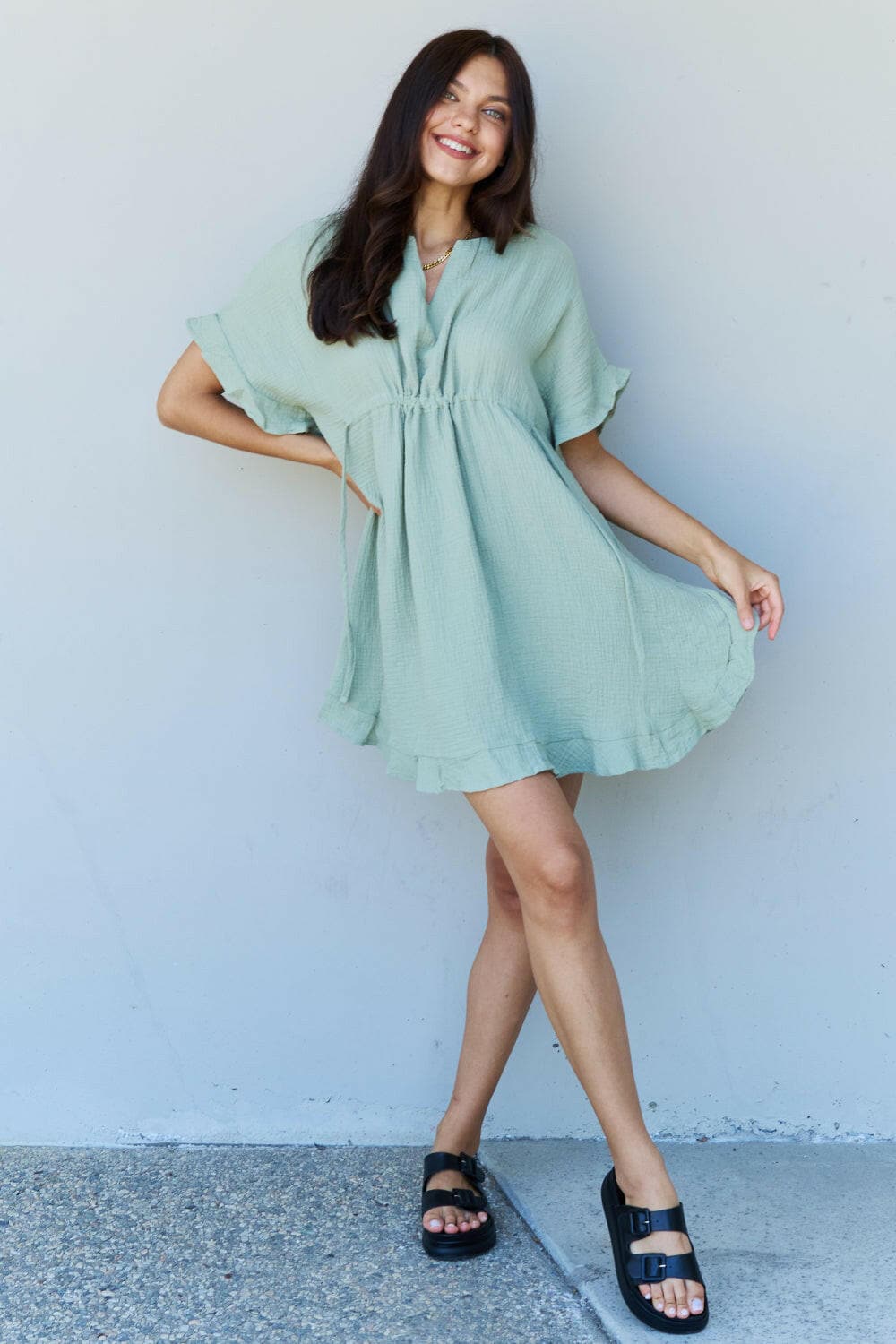 Ninexis Out Of Time Full Size Ruffle Hem Dress with Drawstring WaistbaExperience Effortless Elegance with the Ninexis Out Of Time Full Size Ruffle Hem Dress in Light Sage. This stunning dress is crafted from 100% cotton, providing a soLove Salve Time Full Size Ruffle Hem DressTIKTOK