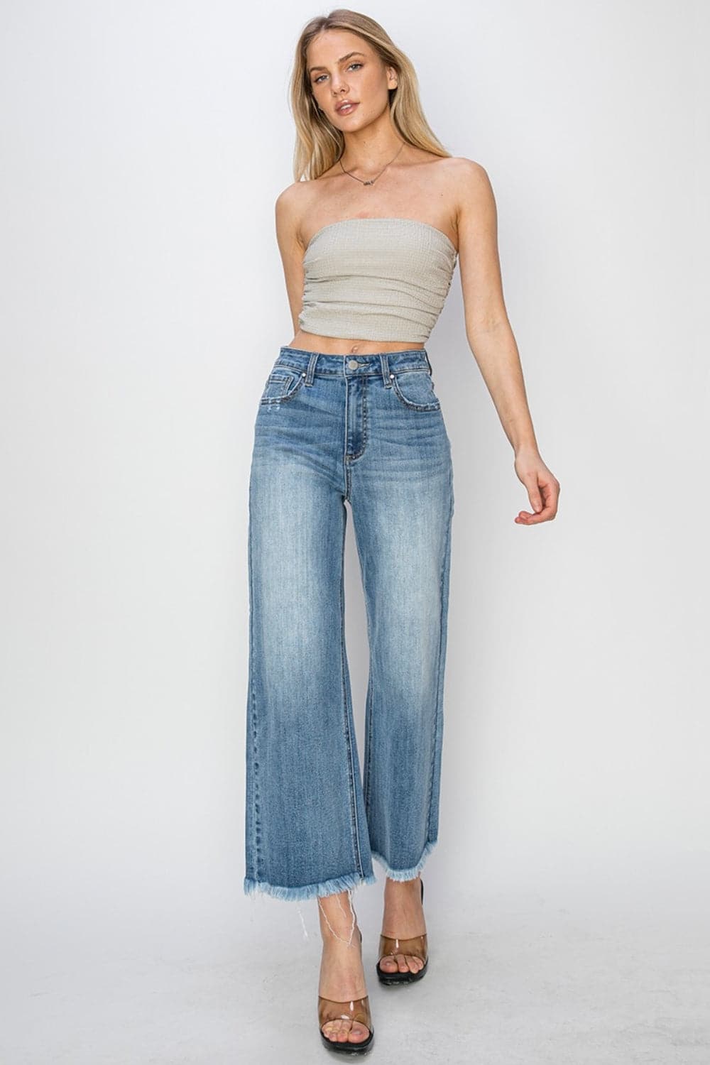 RISEN Raw Hem Cropped Wide Leg JeansHigh Rise Raw Hem Cropped Wide Leg Jeans are the perfect addition to your wardrobe. With their high rise fit, raw hem detail, and wide leg silhouette, these jeans ofLove Salve RISEN Raw Hem Cropped Wide Leg JeansJeans