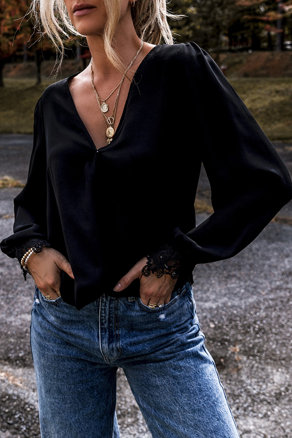 Elegant black lace V-neck blouse with crochet cuffs