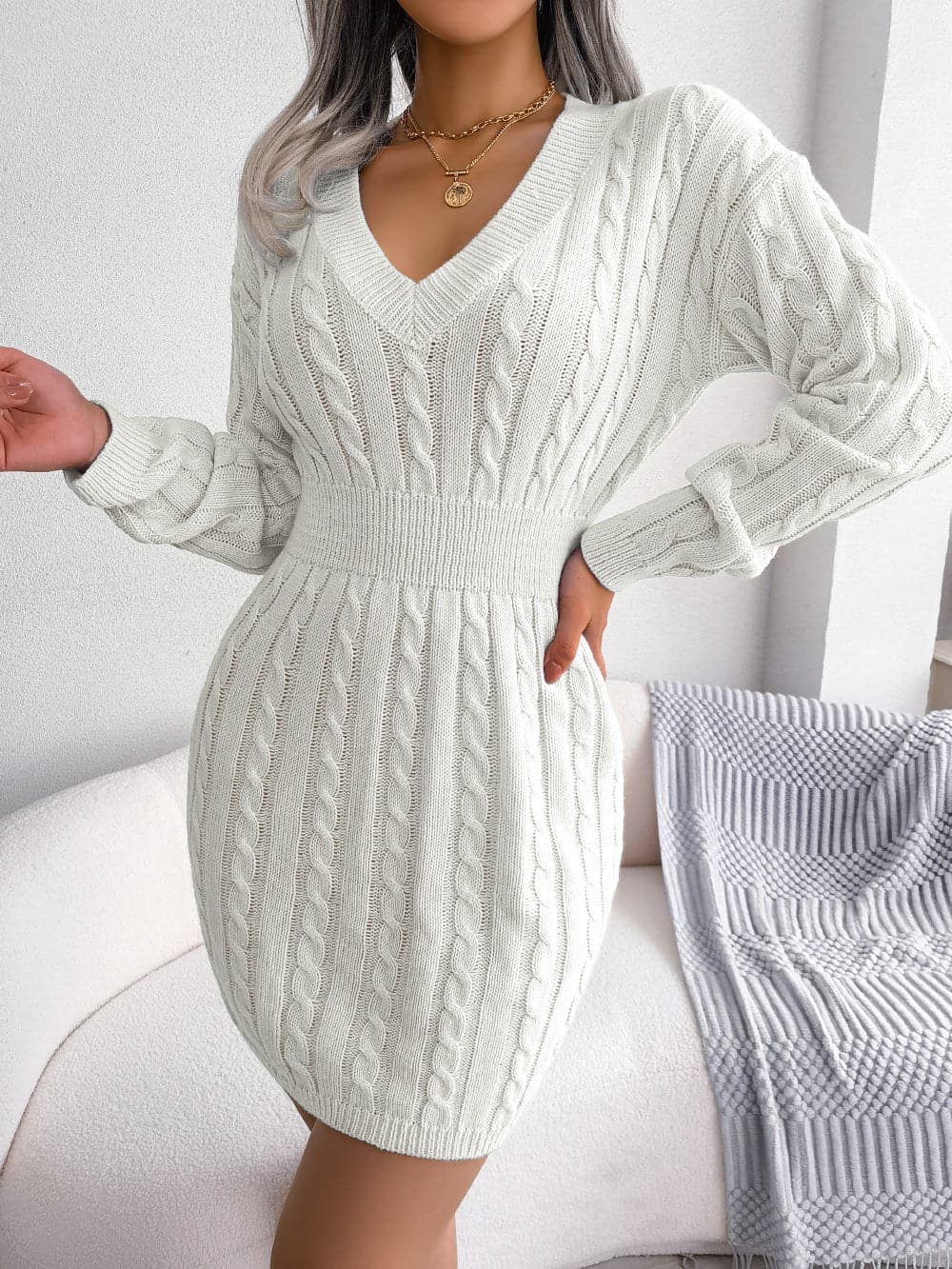 Chic cable-knit v-neck mini dress with long dropped sleeves in soft acrylic.