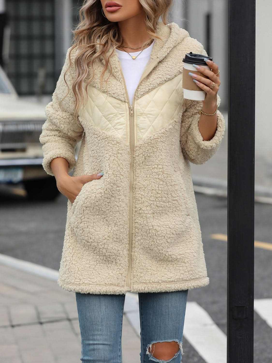 Cozy fleece hooded jacket with pockets worn by model outdoors.