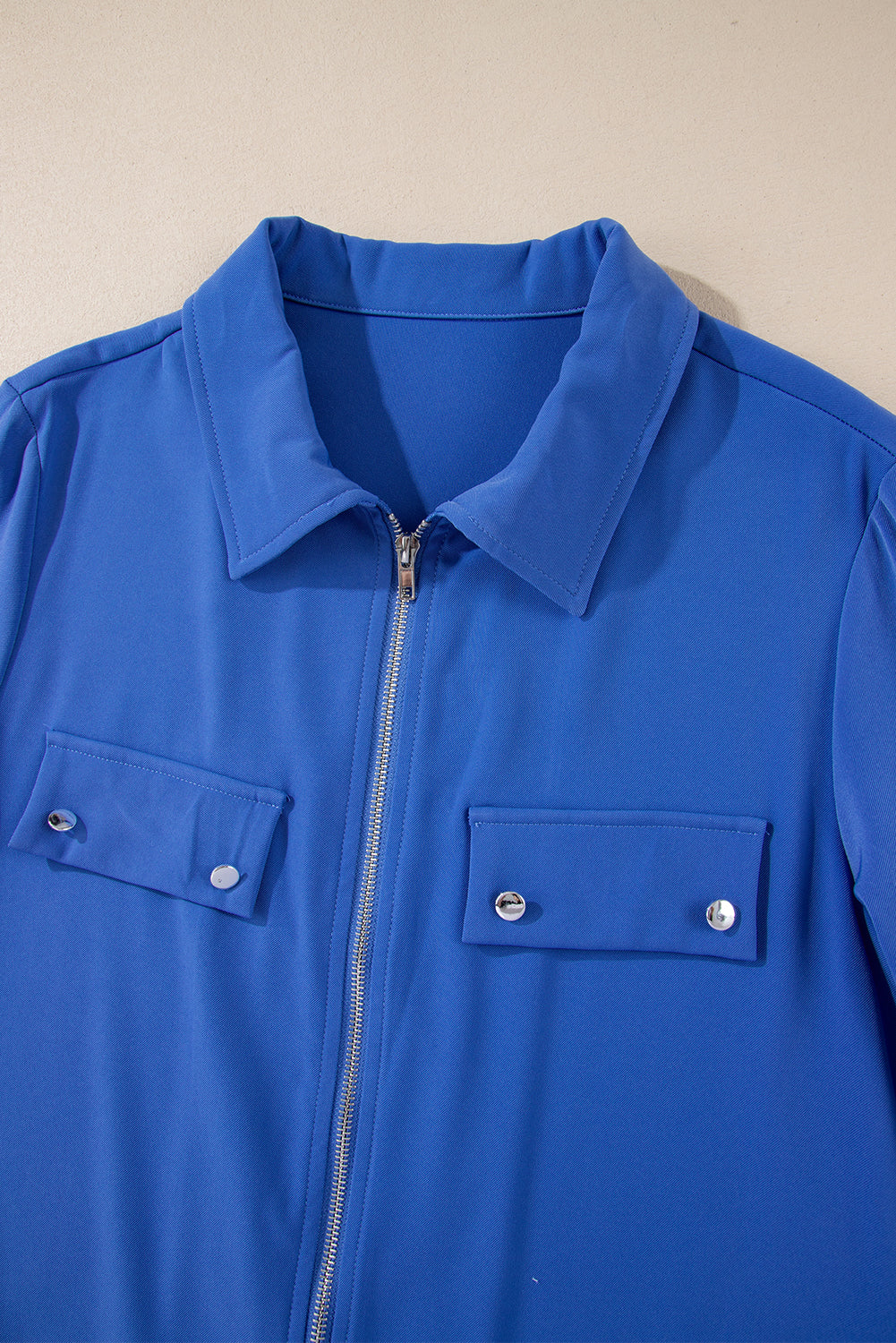 Dusk Blue Zip-Up Jacket with Tab Sleeves and Flap Detail