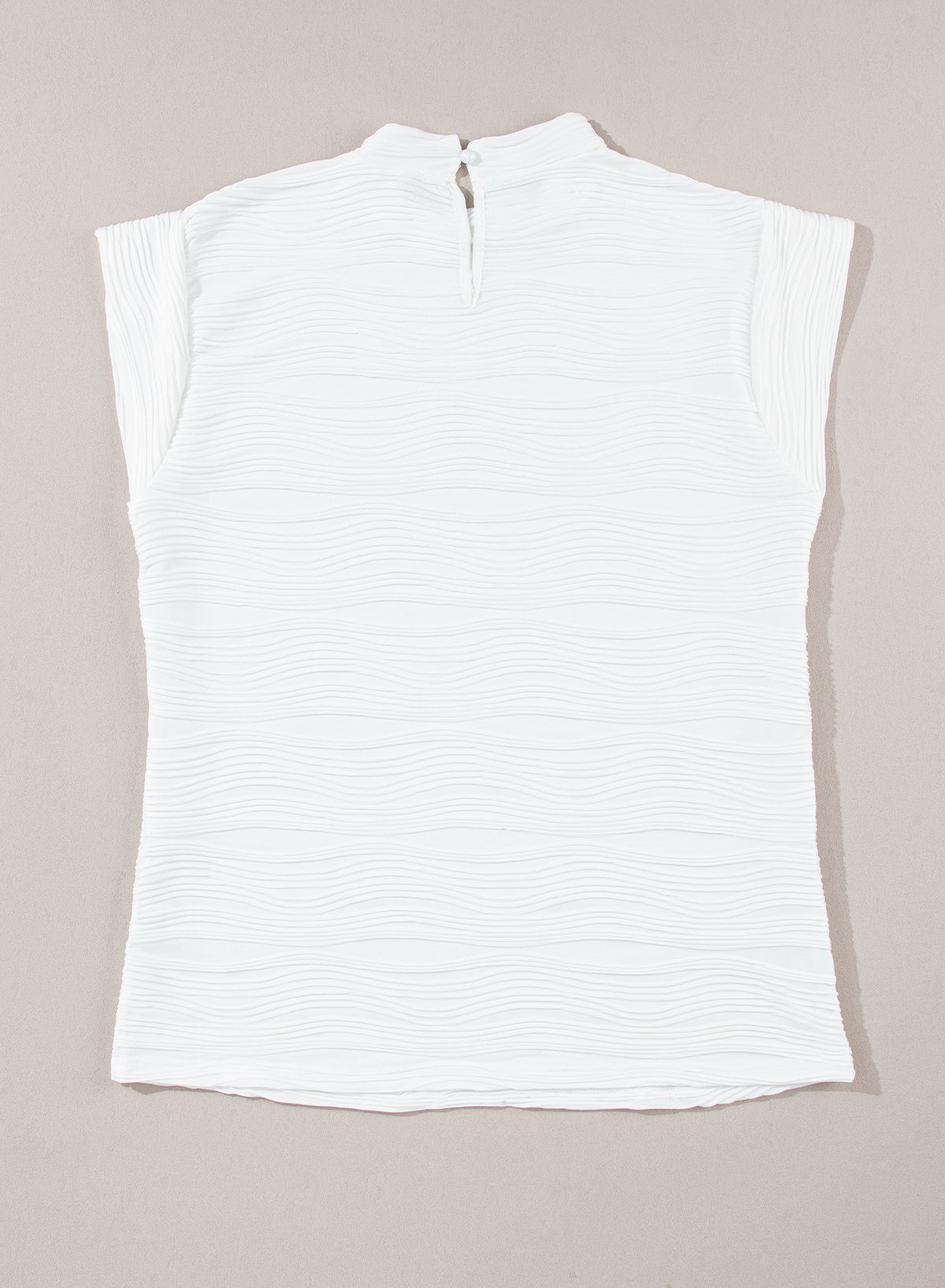 Elegant white textured mock neck top with cap sleeves