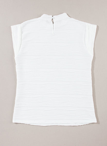 Elegant white textured mock neck top with cap sleeves