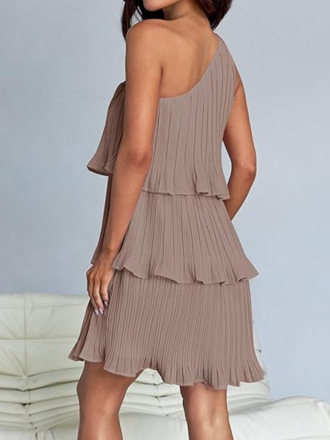 Chic sheer mini dress with ruffles in beige, featuring layered design and slight stretch.