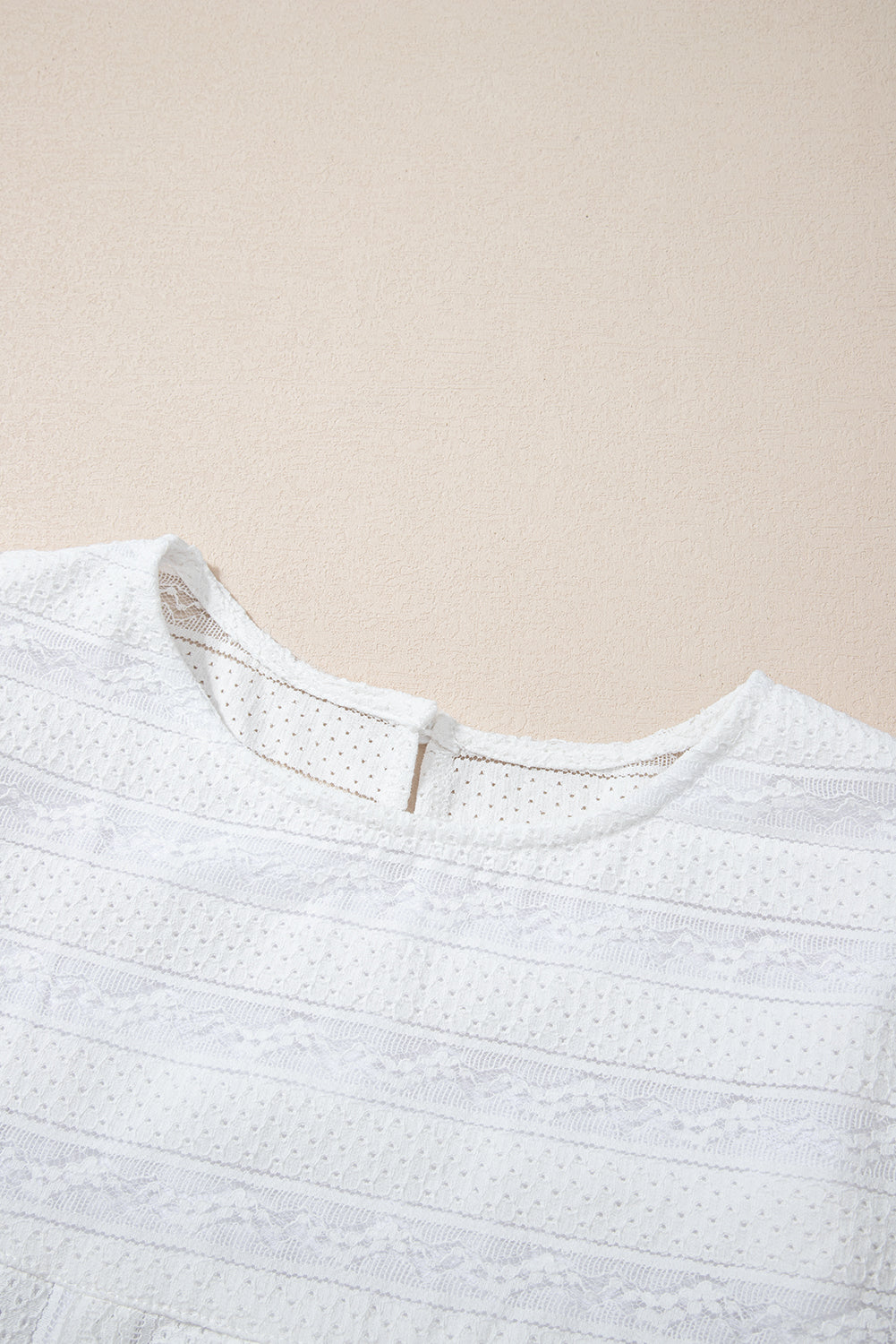 Lace-trimmed white flowy tank top with ruffled accents