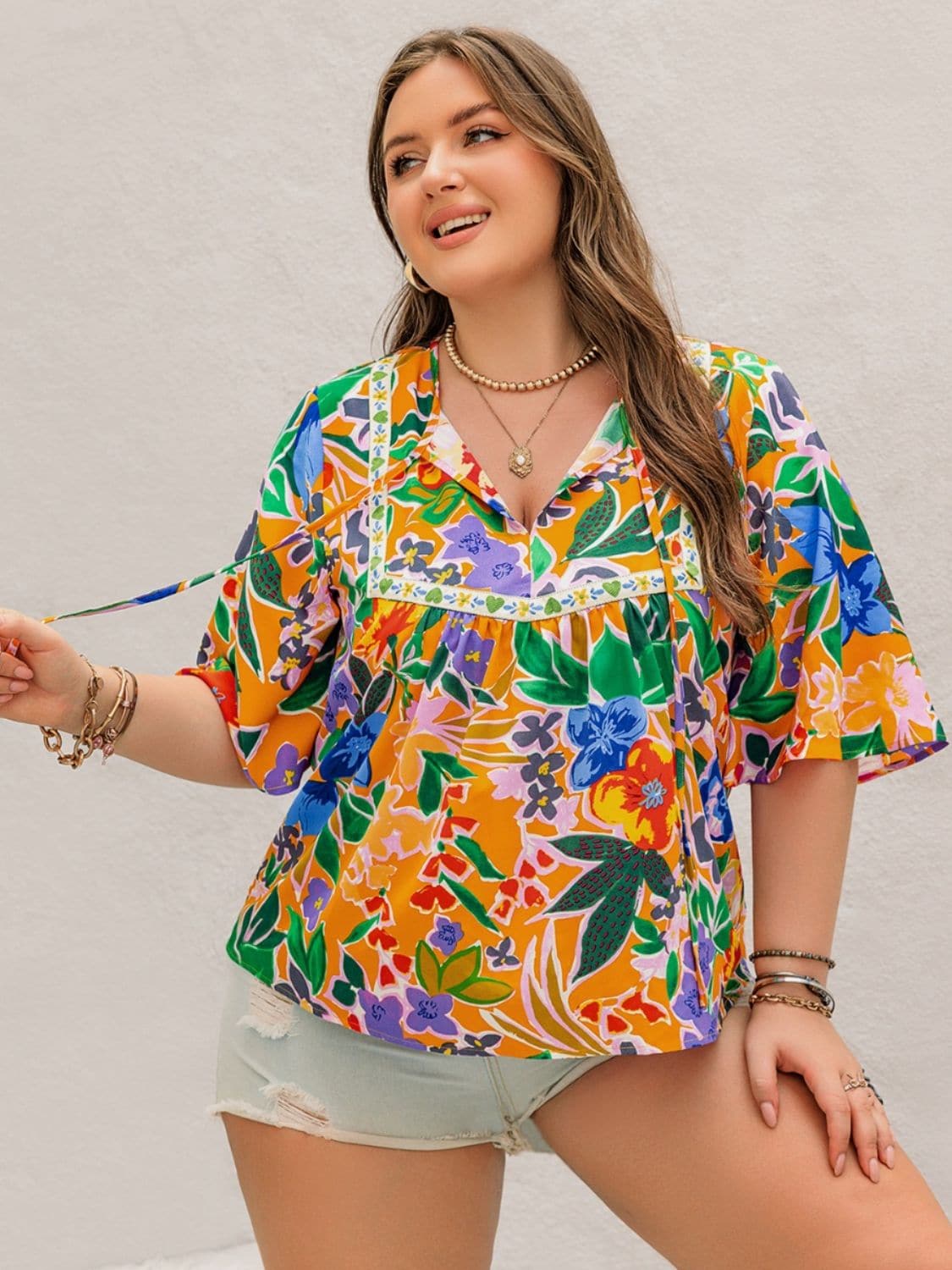 Plus Size Printed Tie Neck Half Sleeve Blouse.