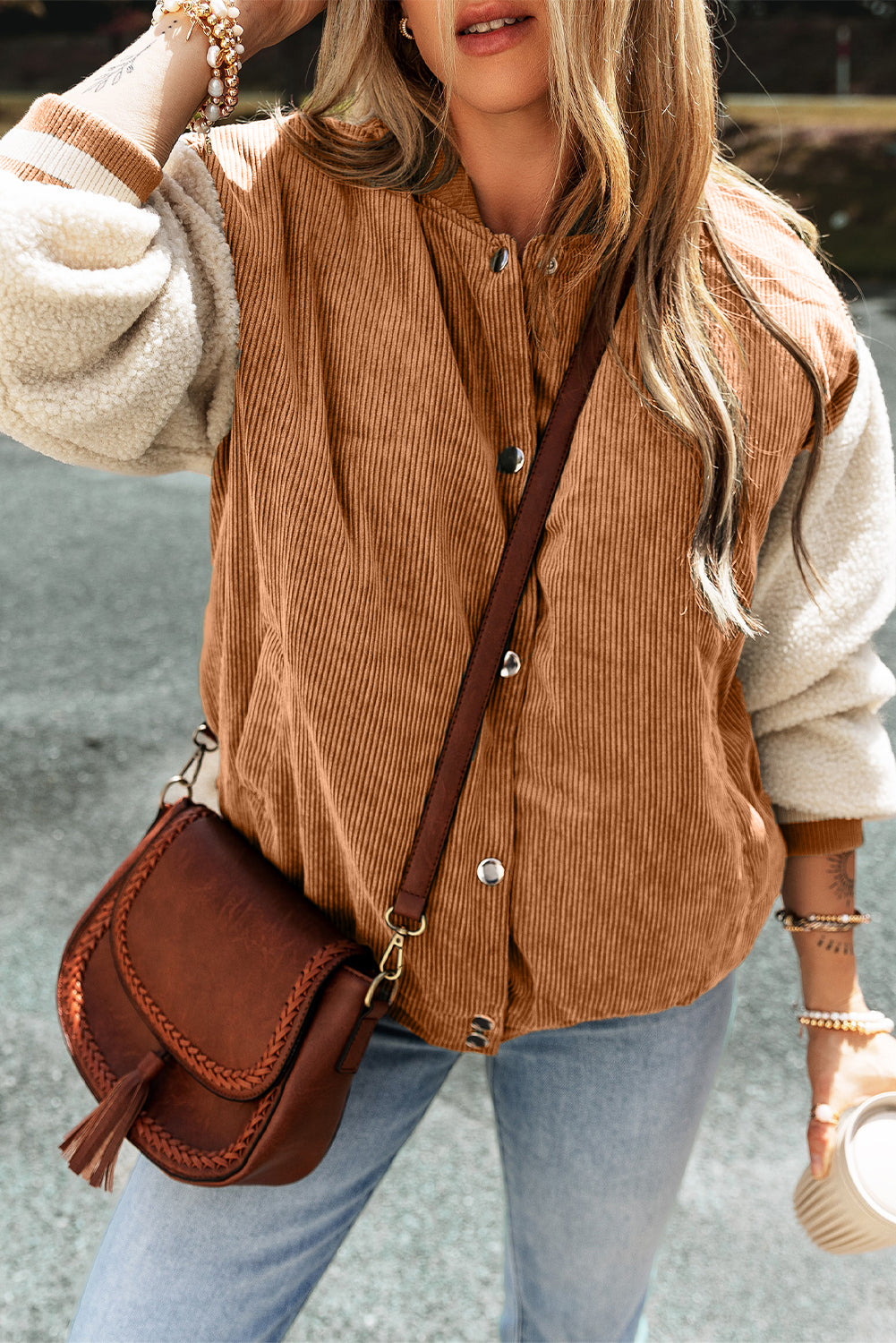 Buckskin corduroy fleece bomber with faux shearling sleeves and snap button front.