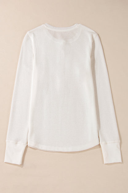 Chic white waffle knit long sleeve top with half button detail