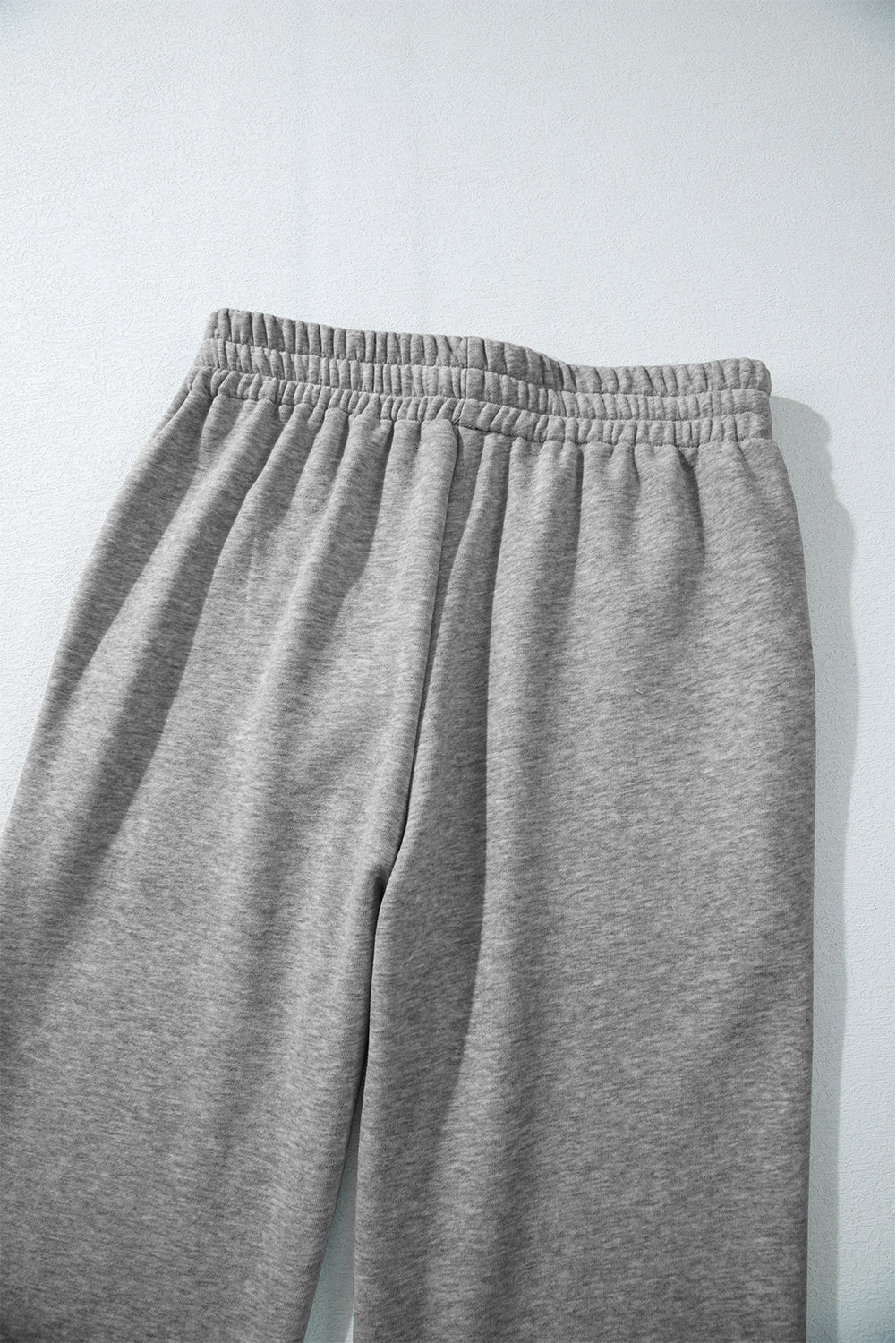 Cozy light grey fleece-lined casual pants with adjustable drawstring waist