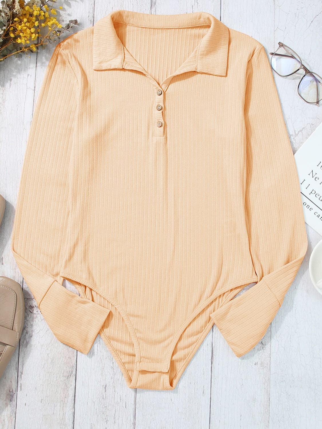 Half Button Collared Neck Long Sleeve Bodysuit.