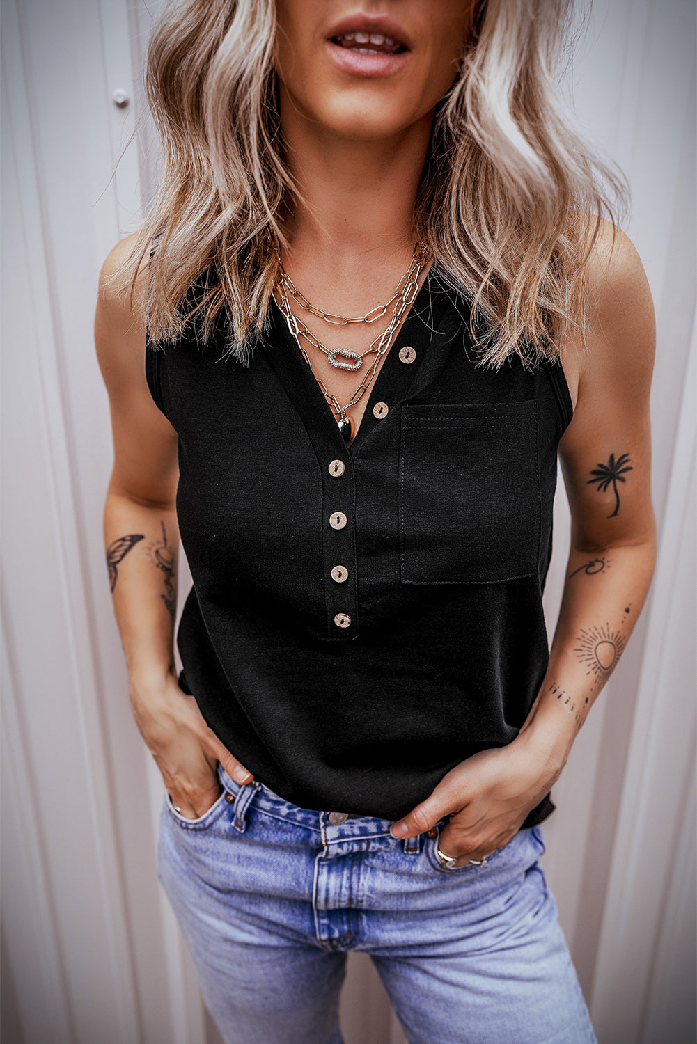 Chic black v-neck tank top with half buttons and patched pocket