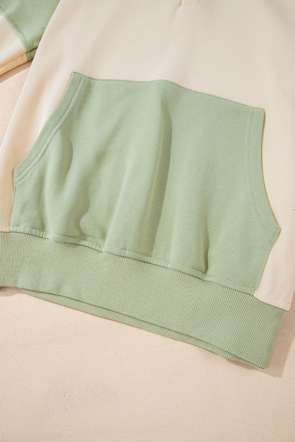 Laurel green colorblock patchwork sweatshirt with buttoned collar and kangaroo pocket