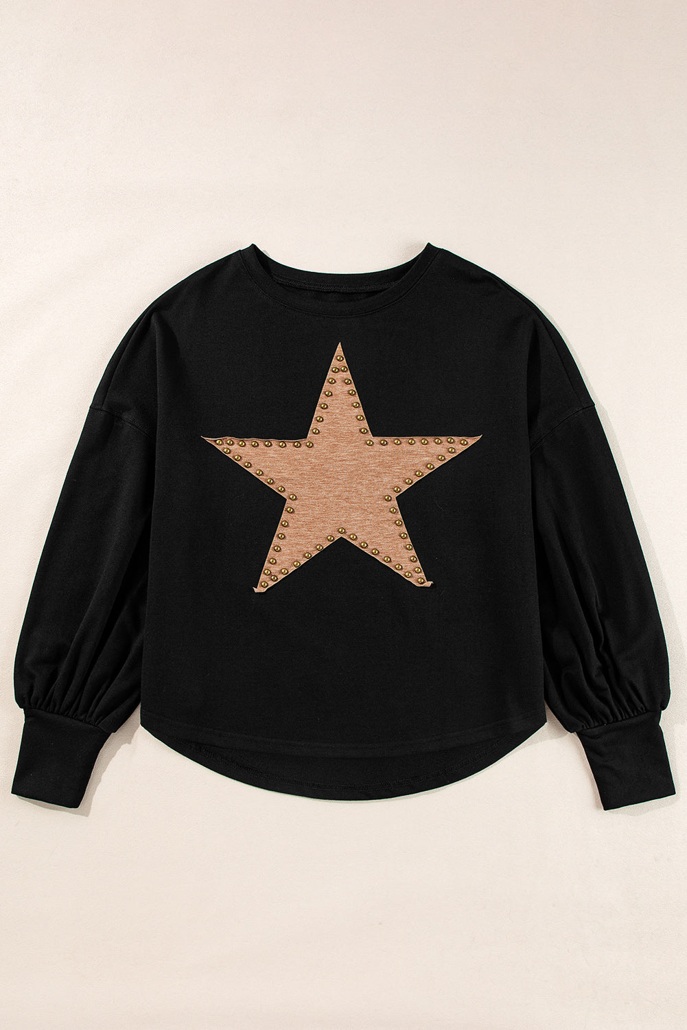 Black oversized top with studded star graphic and long sleeves.