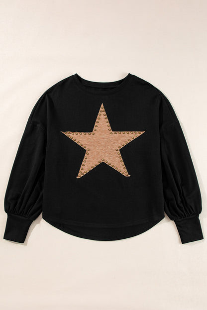 Black oversized top with studded star graphic and long sleeves.