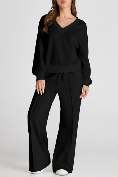 Chic black v-neck long sleeve activewear set with wide leg pants.