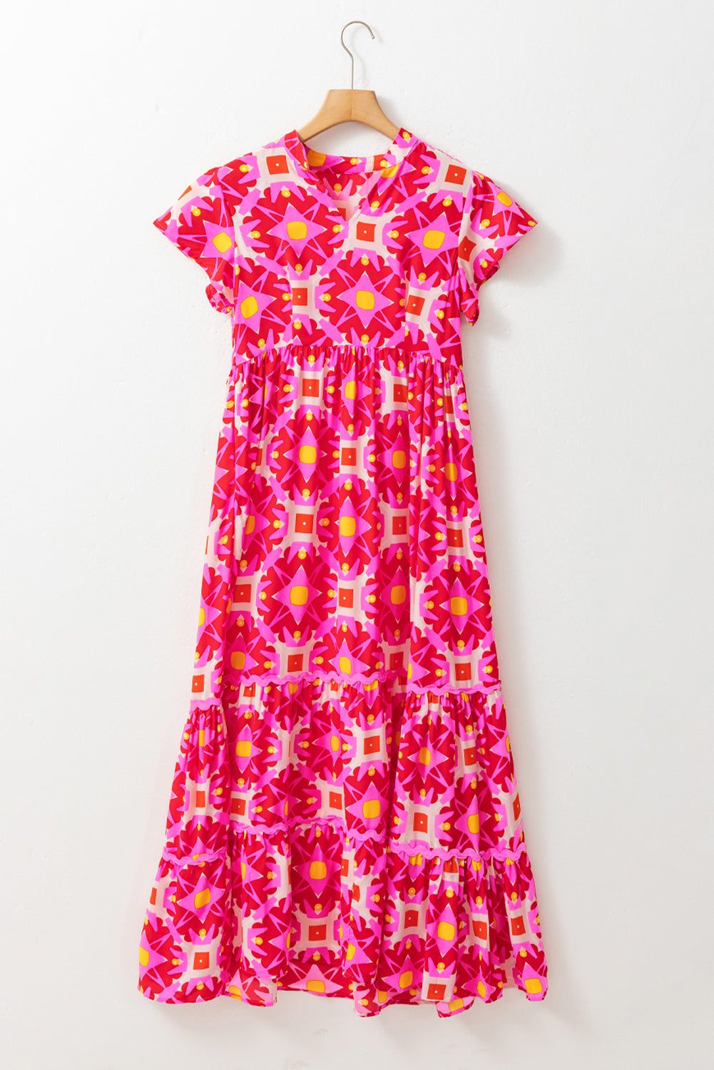 Strawberry pink geo print maxi dress with short sleeves and abstract pattern.