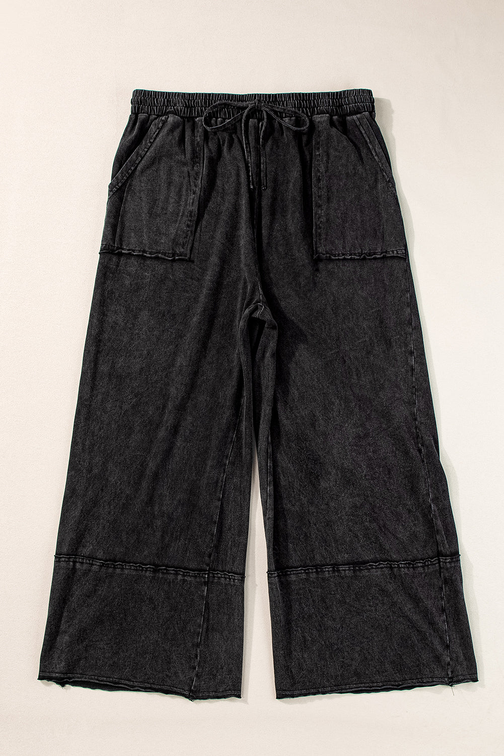 Chic black mineral wash wide leg cropped pants with exposed seams