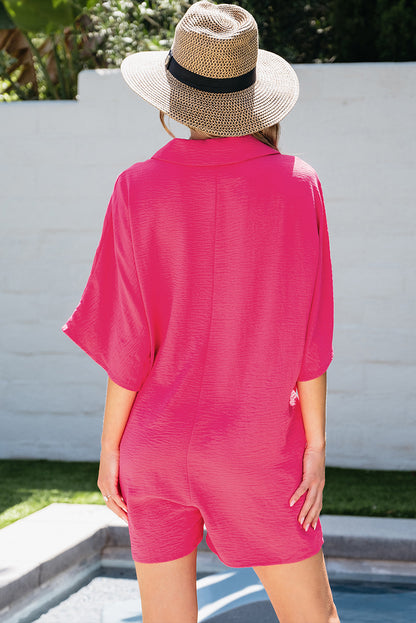 Vibrant pink oversized half-button collared romper for effortless style