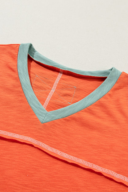 Grapefruit orange exposed seam V-neck tee with contrast trim