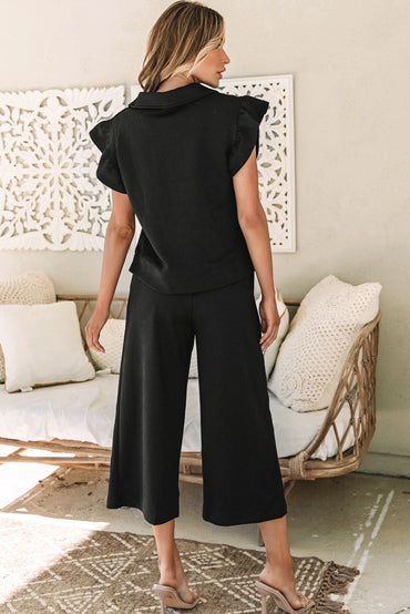 Chic black flutter sleeve top and wide-leg pants ensemble