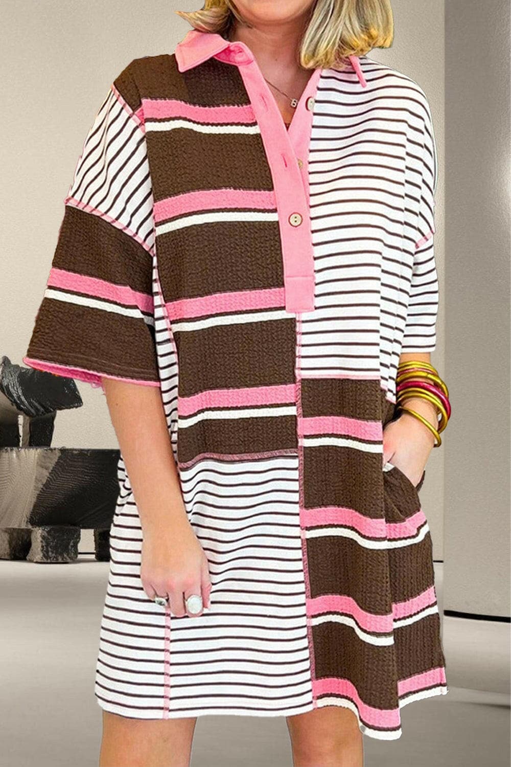 Chic striped collared mini dress with half sleeves, buttoned detail, and trendy pattern.