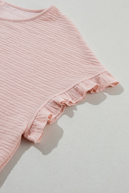 Chic light pink ruffled short sleeve blouse with textured elegance