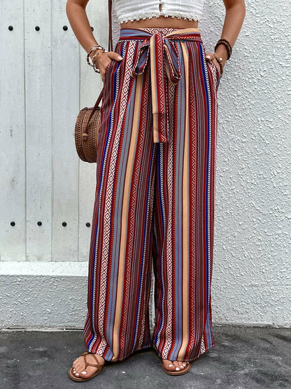 Tied geometric wide-leg pants with a colorful pattern and pockets, perfect for a trendy look.