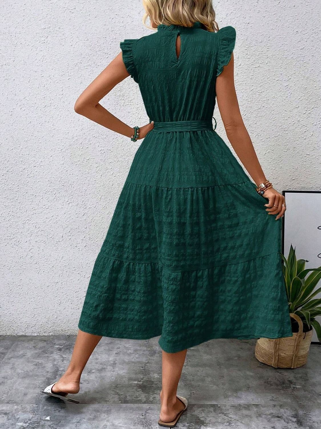 Ruffled cap sleeve midi dress in green with tied waist and textured fabric.