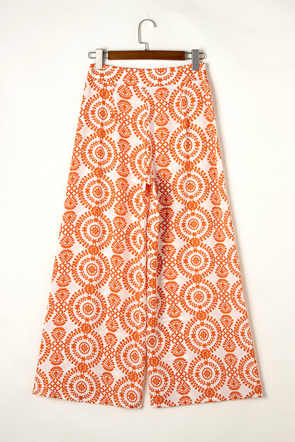 Chic orange bohemian wide leg pants with retro floral design