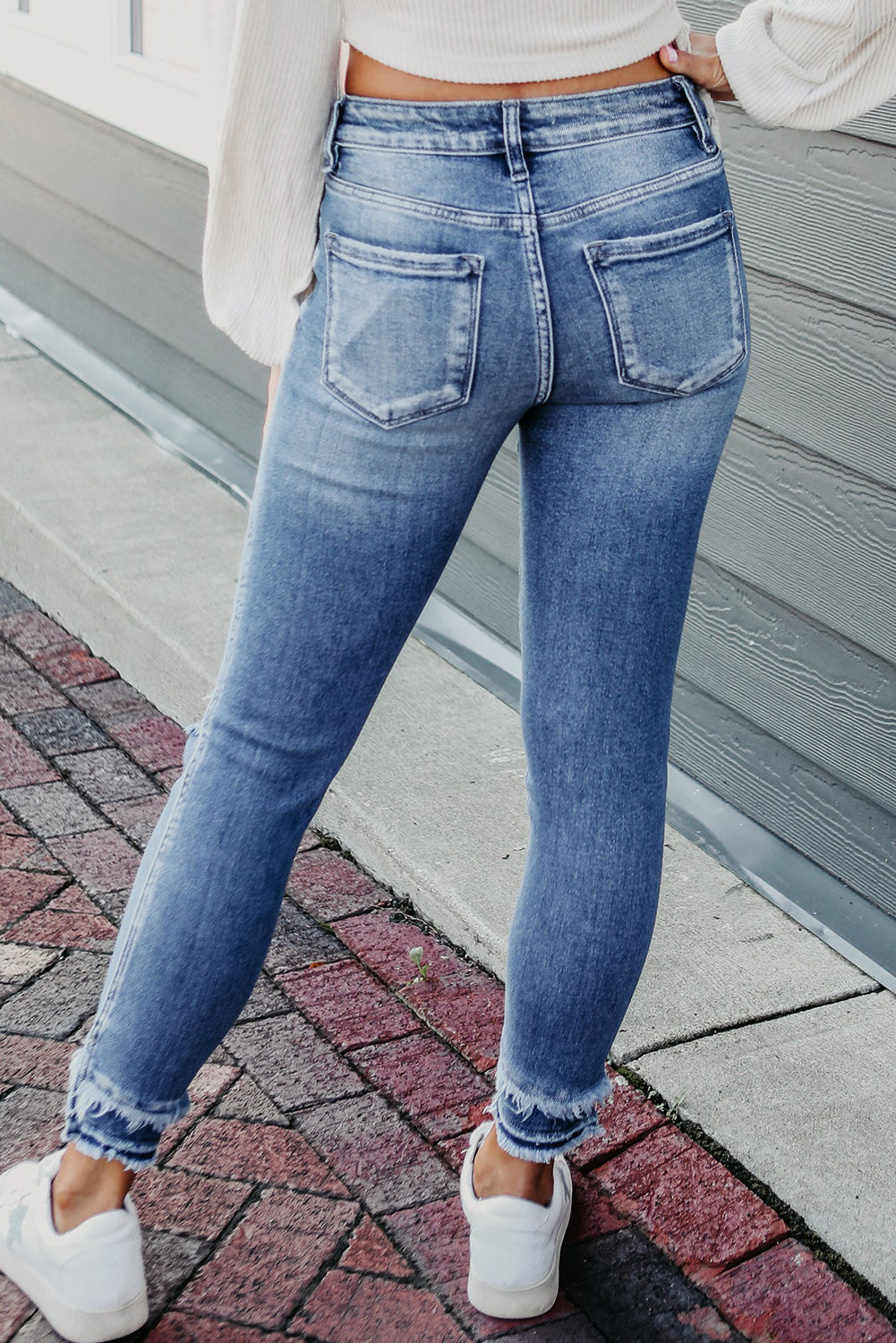 Retro light blue frayed ankle skinny jeans with a distressed finish