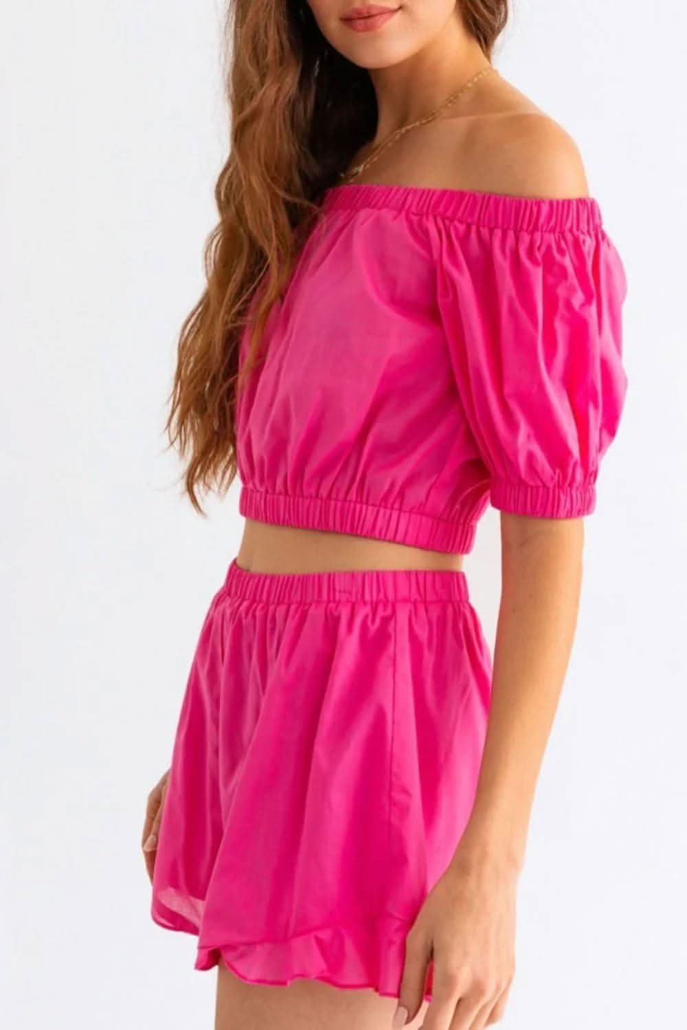 Chic off-shoulder crop top and playful ruffled shorts set