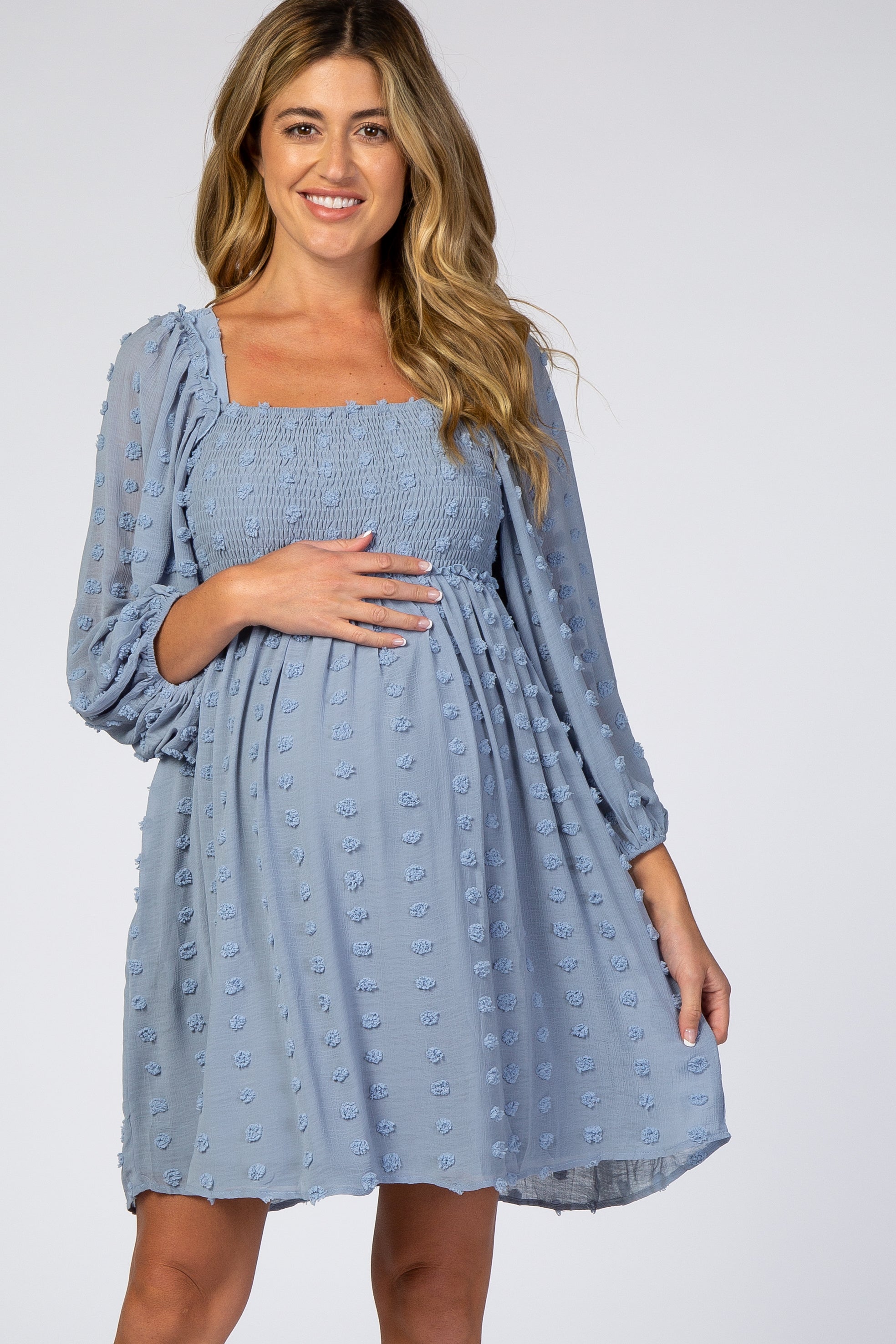 Close-up of textured dot fabric and smocking detail on maternity dress