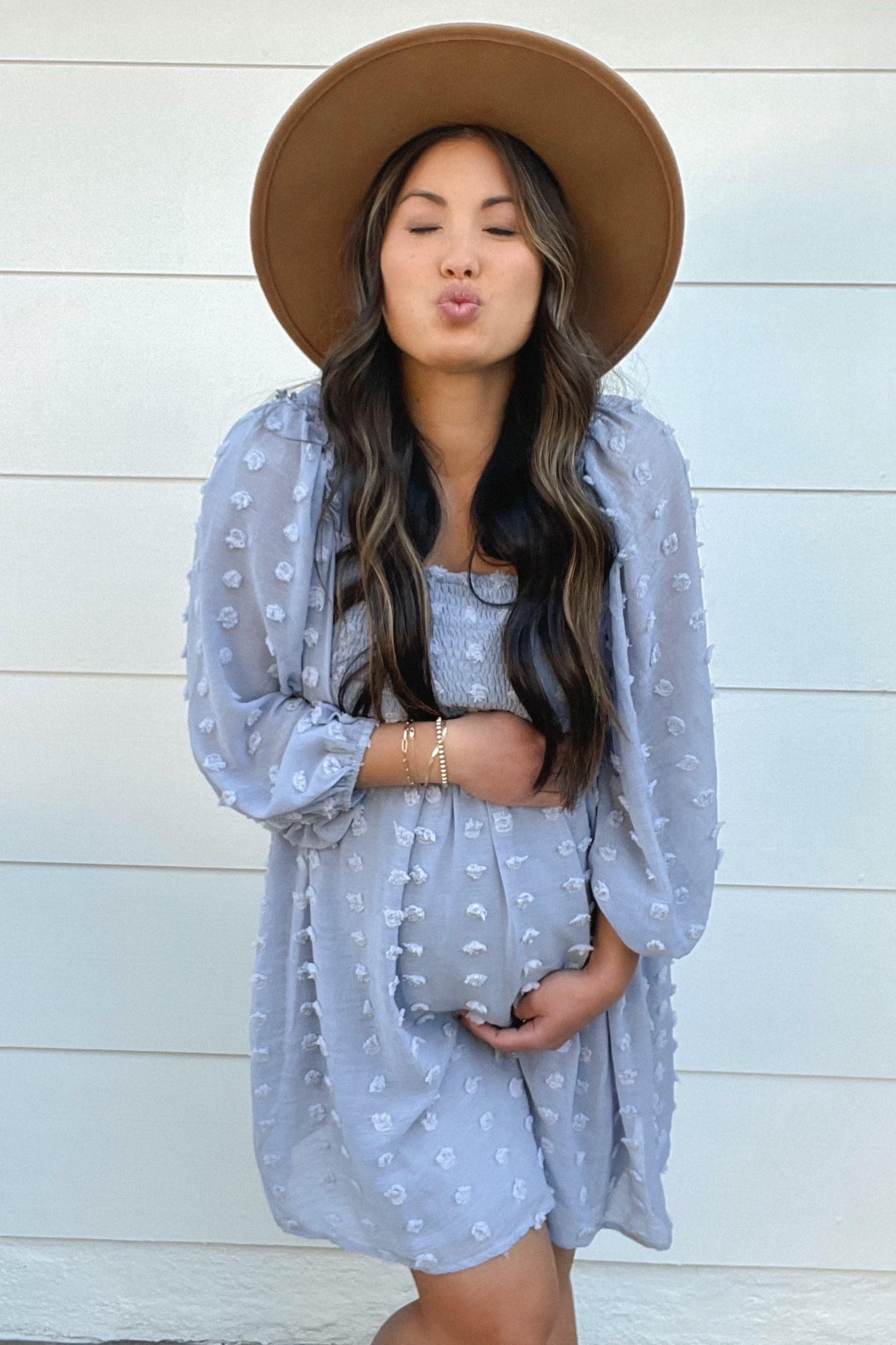 Light blue chiffon maternity dress with smocked detailing and dot pattern