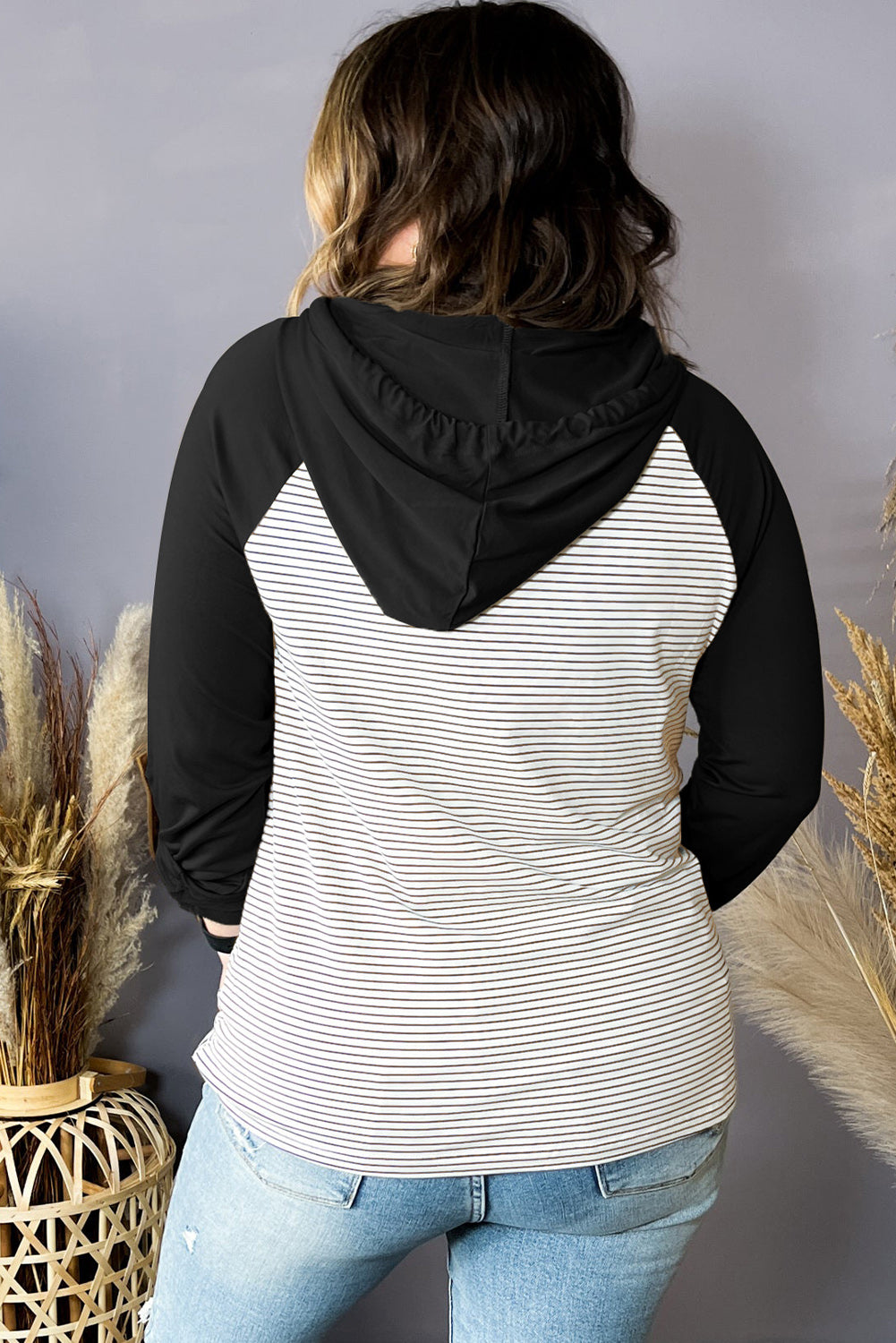 Plus size black and white striped hoodie with raglan sleeves and button pocket