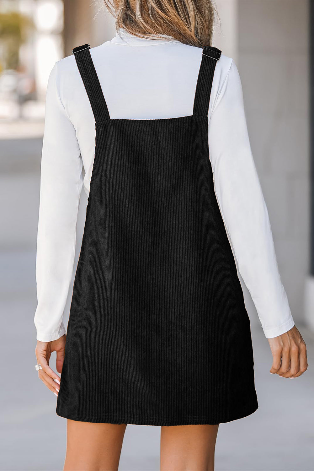 Chic black sleeveless corduroy overall dress with front pockets